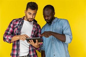 Two boys are surprised while watching the tablet photo