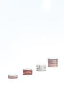 Stacks of coins on a white background photo