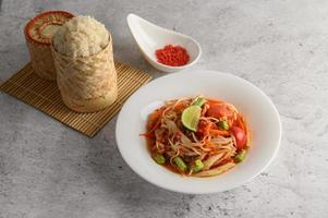 Thai papaya salad with ingredients photo