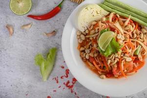 Thai papaya salad with ingredients photo