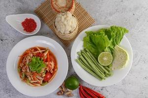 Thai papaya salad with ingredients photo