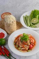 Thai papaya salad with ingredients photo