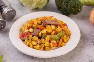 Pork dish with carrots and corn photo
