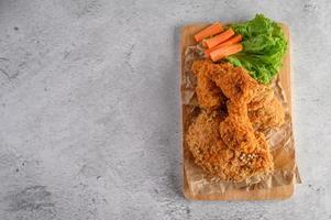 Crispy fried chicken on a cutting board photo