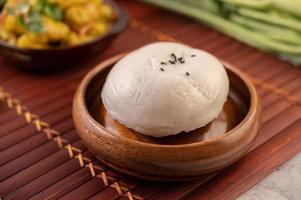 Steamed buns in a wooden dish photo