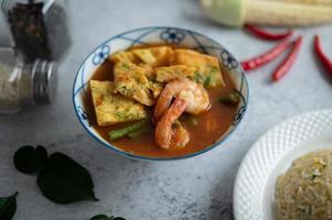 Hot and sour soup with cha-om, egg, and shrimp photo
