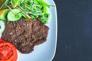 Steak with lettuce on a plate photo