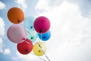 globos de colores contra un cielo azul foto