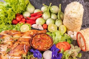 Grilled chicken with sticky rice and vegetables photo