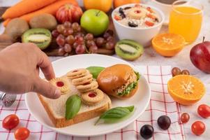 Bread slices with cookies and vegetables and a burger photo