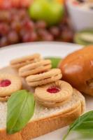 Bread slices with cookies and vegetables and a burger photo