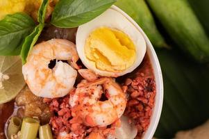 Tom yum noodles with shrimp and boiled eggs photo