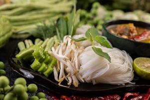 Rice noodles with beans, tomatoes, melon and chilies photo