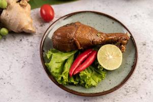 Braised chicken leg with lettuce, chili and lime