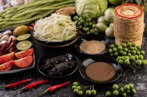 Papaya salad ingredients with fermented fish photo