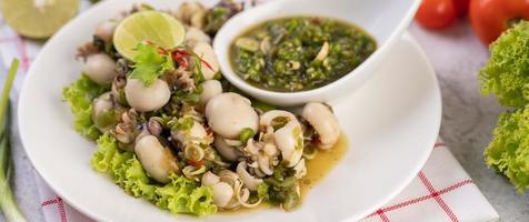 Spicy squid salad with onion and chilies photo