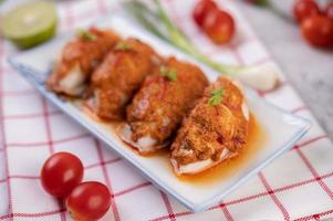 Chu che squid with spring onion, tomato, lemon and chilies photo