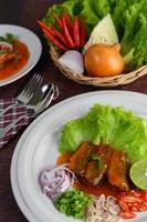 Sardine spicy salad and sides arranged nicely photo