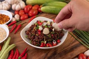 Hand dipping spicy minced meat photo