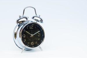 Black alarm clock isolated on a white background photo