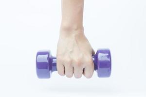 Hand holding a dumbbell on a white background photo