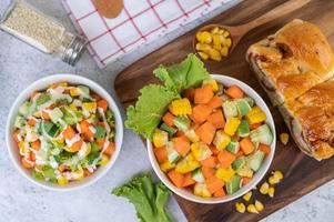 Cucumber, corn, carrot and lettuce salad photo