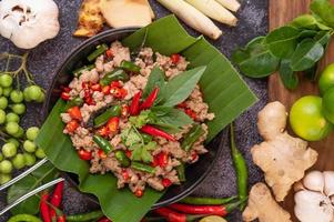 Stir-fried pork basil on banana leaves photo