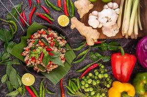 Stir-fried pork basil on banana leaves photo