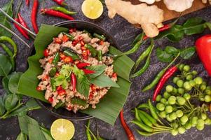 Stir-fried pork basil on banana leaves photo