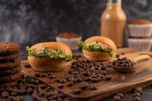 Burgers with coffee beans on a brown wooden slab photo