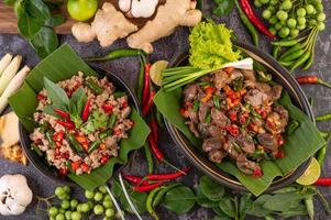 Stir-fried basil chicken liver on banana leaves photo