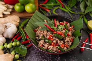 Stir-fried pork basil on banana leaves photo