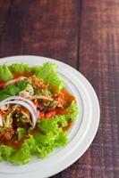 Spicy salad with sardines in tomato sauce photo