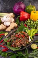 Stir-fried basil chicken liver on banana leaves photo