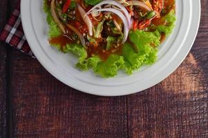 Spicy salad with sardines in tomato sauce photo