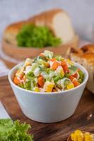 Cucumber, corn, carrot and lettuce salad photo