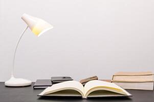 Book and lamp on the table photo