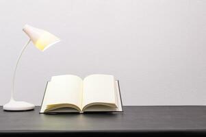 Book and lamp on the table photo