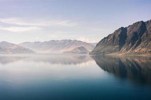 Still water near mountains photo