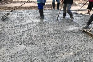 People raking concrete photo