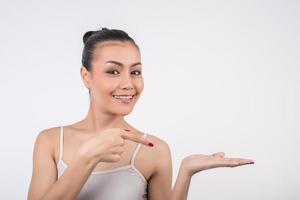 Young woman poses with empty hand on white background photo