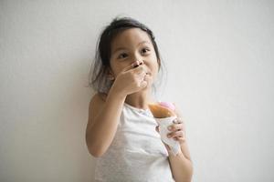 Portrait of a little girl eating ice cream photo