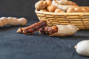 Fresh tamarind on  a black surface photo