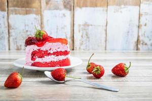 Strawberry cake on a rustic wooden table photo