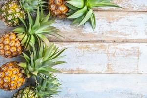 Pineapple on a wooden background photo