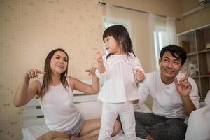 Happy child with parents playing photo