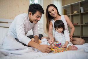 Happy child with parents playing at home photo