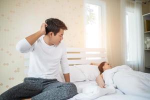 Upset man on the bed after arguing with his girlfriend
