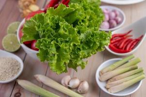 Red onions, lemon, lemongrass, chilies, garlic, galangal, and lettuce photo