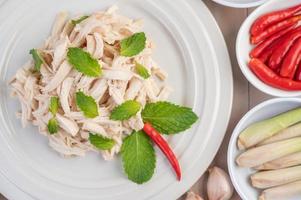 Chicken salad on a white plate with mint leaves photo